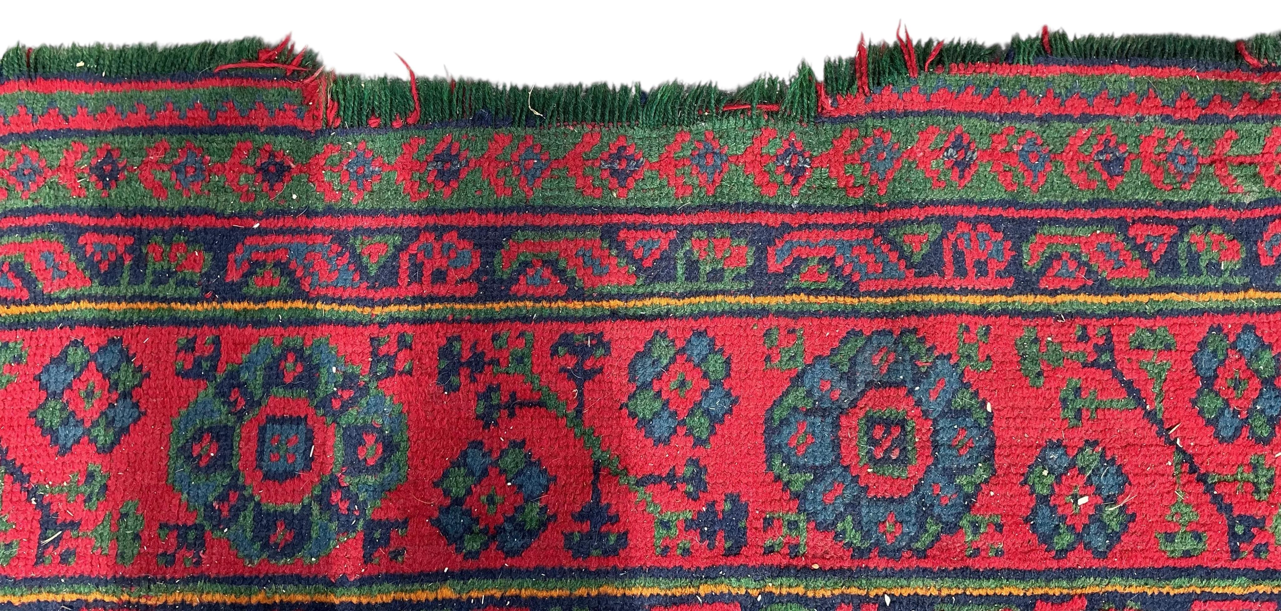 An early 20th century Afghan red ground carpet, 445 x 375cm